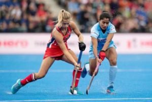 Woman Hockey players in a tussle for ball possession