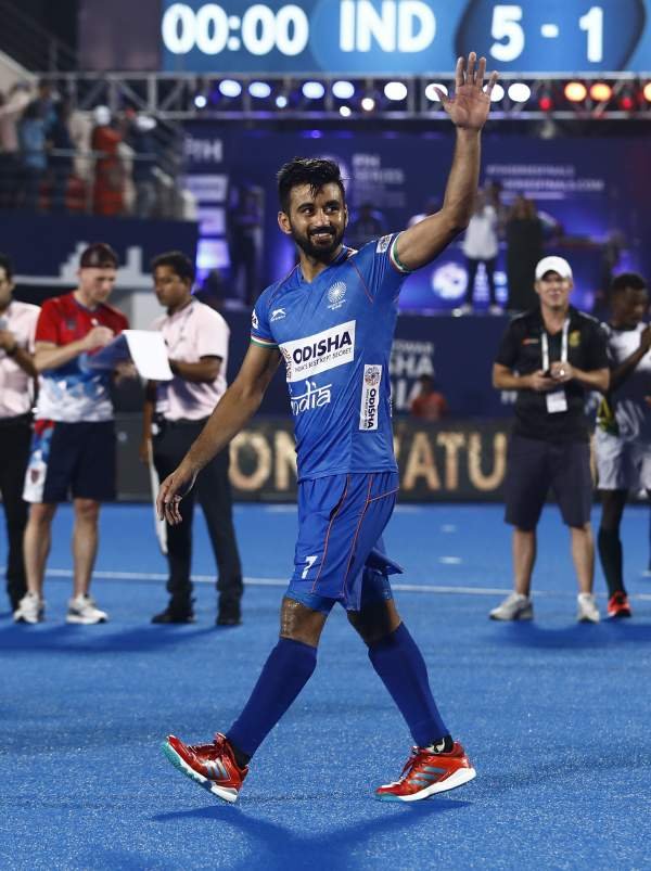 Hockey Captain Manpreet Singh waves to crowd acknowledging its cheers